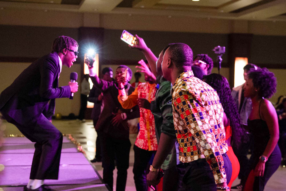 Jeremiah “Jerry” Serugo sings along to Jordan Kayemba's piano playing and a pre-recorded track during the Afro Karibbean Night talent show. After showering the audience in fake $100 bills, Serugo and Kayemba won the contest and took home a gift card prize.