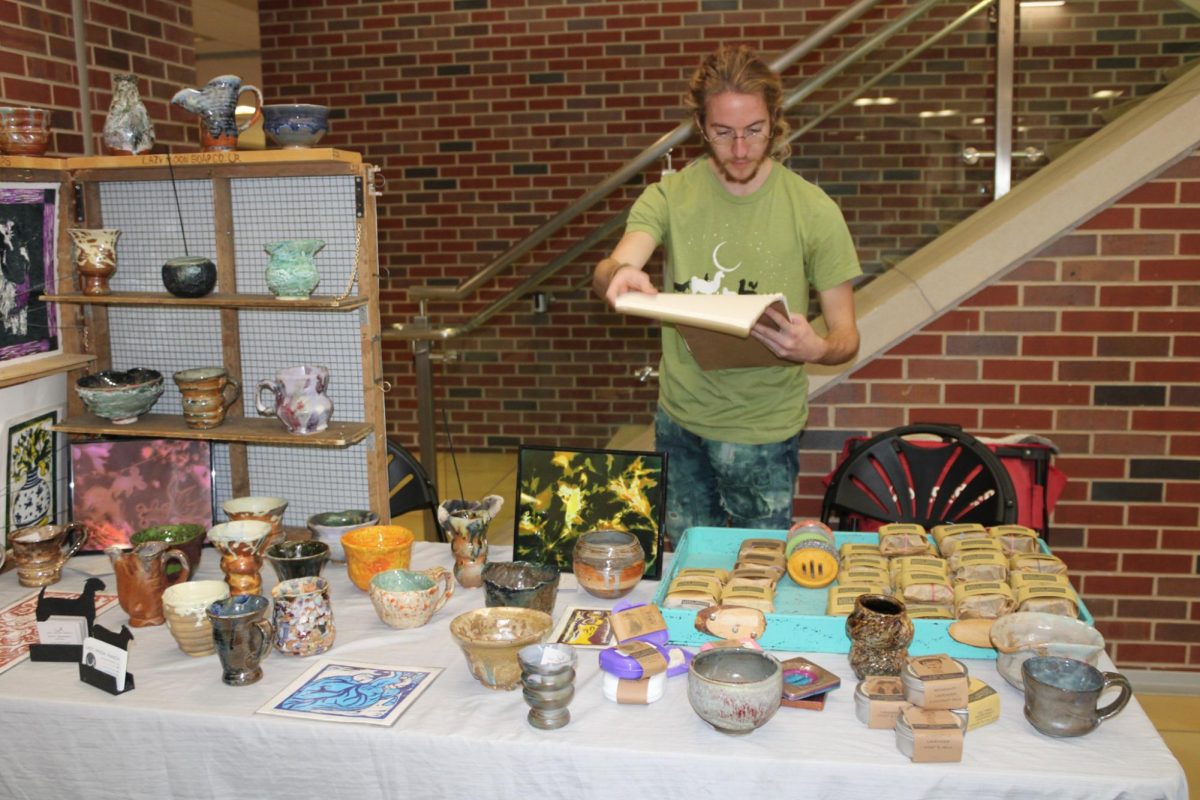 Wyatt Pankratz, a member of the WSU Ceramic's Guild, sells his work at the 2023 Art Market. This year, he partook in the Holiday Art Sale to sell more of his ceramic pieces. 