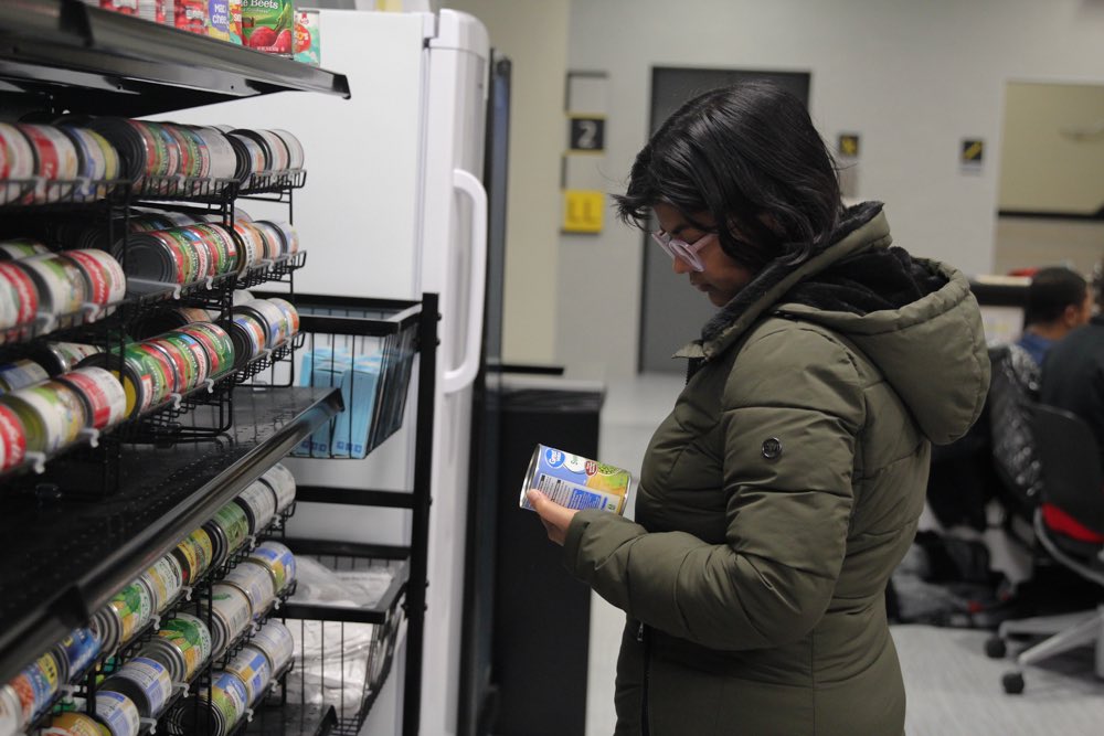 Khushboo Singh looks at items in the Shocker Support Locker. Over winter break, the locker is closed so food will be provided to students on campus through student housing.