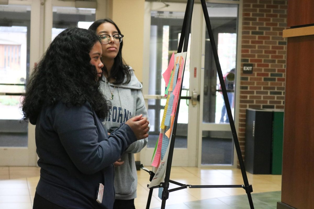 A student places their story on a board at ADI's “Hidden Stories” event in the RSC. The event invited students out of their comfort zone to share a story pertaining their identity.