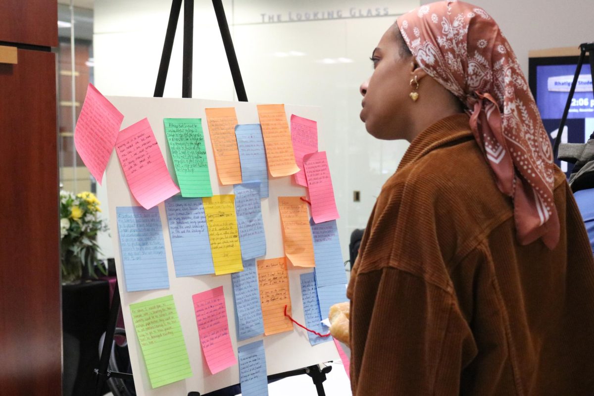 A Wichita State Student looks at a board of stories displayed during Diversity Week in the RSC. On Nov. 4, the Ambassadors for Diversity and Inclusion held a “Hidden Stories” event where international students' experiences were on display for others to see.