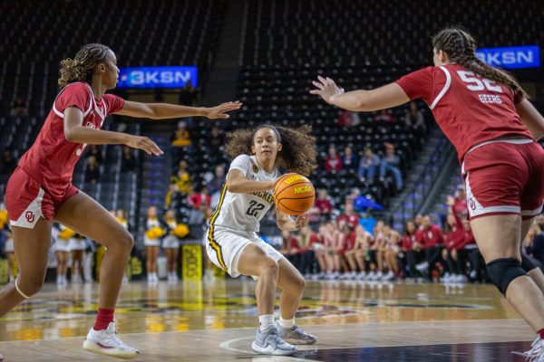 Jasmine Peaks gets surrounded by Oklahoma defenders on Nov. 19. WSU lost the game, 79-49.