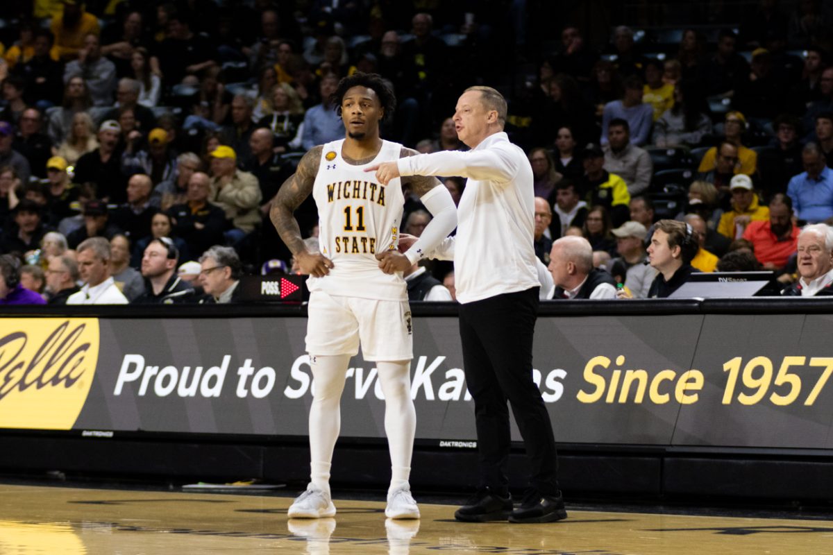 Fifth-year senior Justin Hill speaks with head coach Paul Mills during a break in play. Hill is new to the team, having transferred from Georgia over the summer.