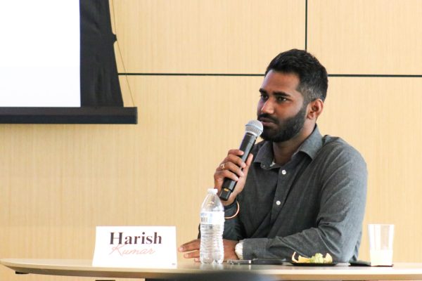 Harish Kumar, a local business owner, introduces himself to students attending the ADI panel Nov. 12.