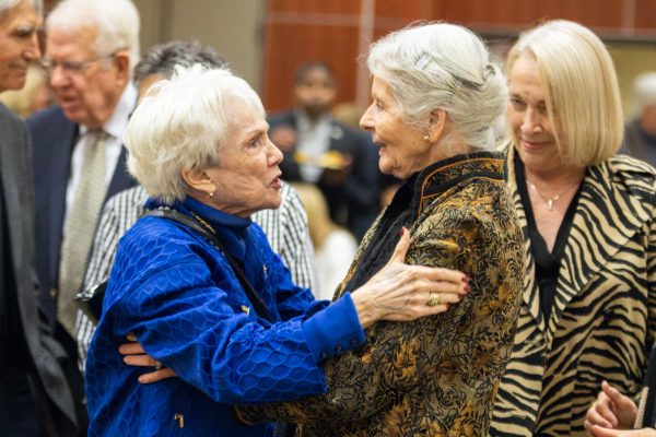 Beverly Rhatigan, the widow of James Rhatigan, is embraced by a family friend while at the reception service hosted at the Rhatigan Student Center. More than 100 friends, family members and former colleagues attended the reception to express their condolences and talk about Rhatian's legacy.