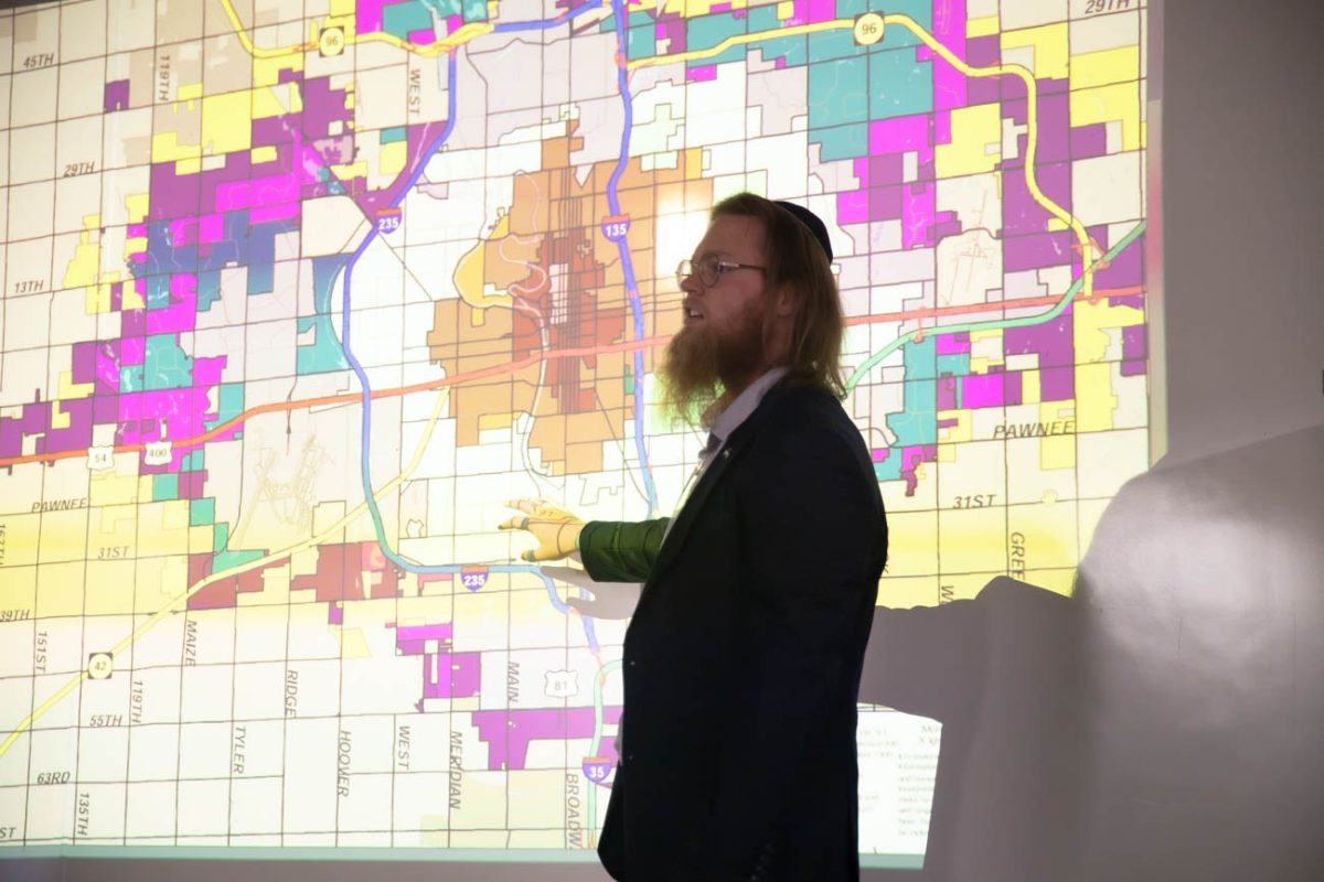 Kian Williams, a student in Local and Community History, shows Wichita on a map, explaining its history.