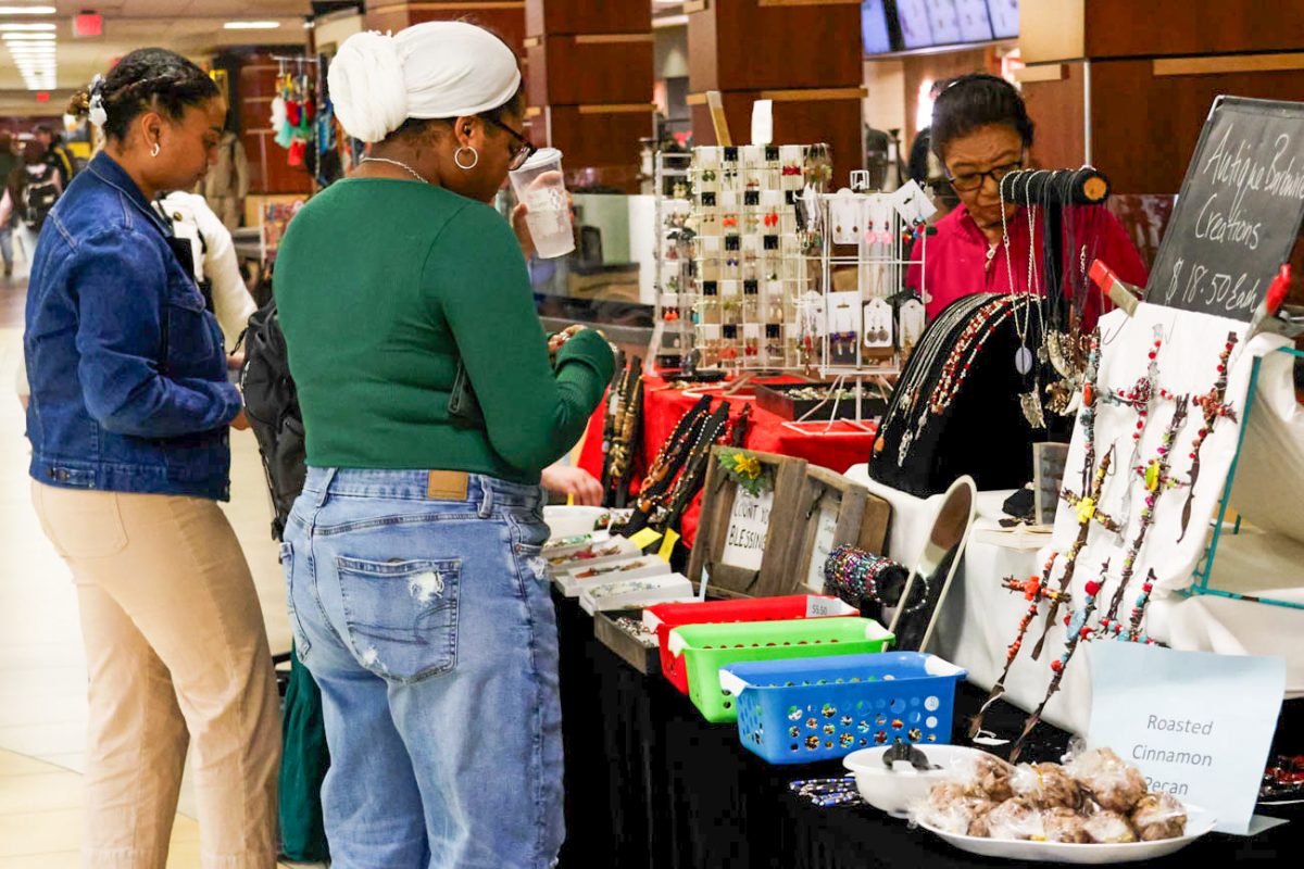 Students admire the jewlery and crafts sold by Barbwire Creations at the Makers Market on Nov. 12.