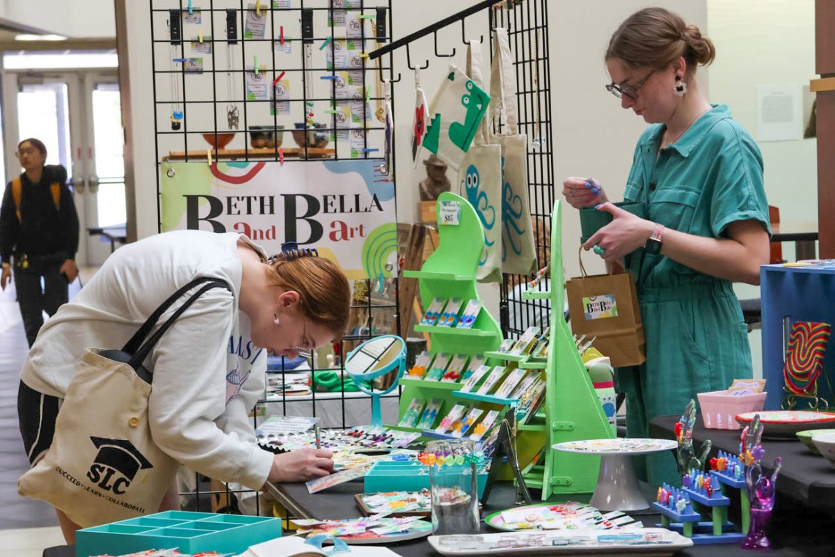 Marin Baucom, a math and data science major, enters a raffle at a booth during the Makers Market on Nov. 12.