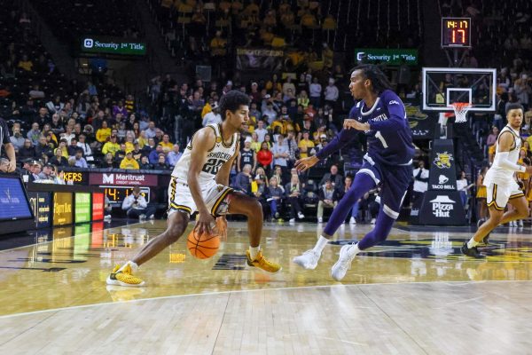 Redshirt senior guard Harlond Beverly dribbles the ball between his legs on Nov. 18.