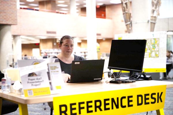 Sara Rue, the the assessment and user experience librarian, works at the reference desk in Ablah Library. Her position was created to focus of improving the experience for people who use the library. 