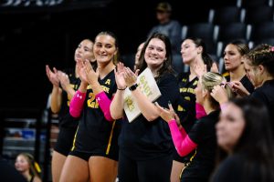 Gabi Maas claps while holding her clipboard during a volleyball game. (Photo by Skylar Kade, courtesy of Wichita State Athletics)
