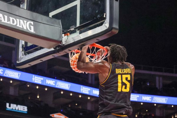 Senior center Quincy Ballard throws down a two-handed slam. Ballard finished the game against Saint Louis with eight points and seven rebounds.