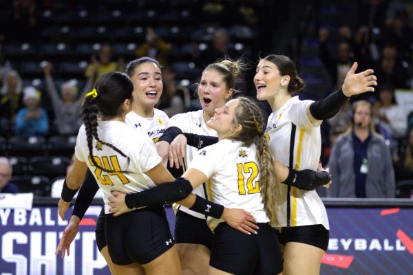 Members of the Wichita State Women's Volleyball team embrace after winning their second consecutive set in their Friday, Nov. 22. The Shockers beat the University of Tulsa in a 3-0 sweep.