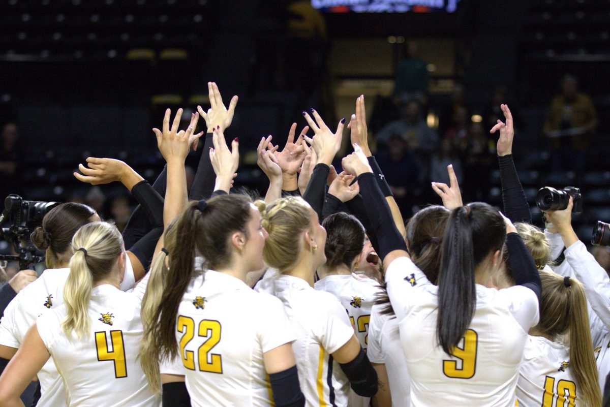 Members of the Wichita State volleyball team huddle up to celebrate after defeating Tulsa on Friday, Nov. 22. The Shockers beat Tulsa in a 3-0 sweep.