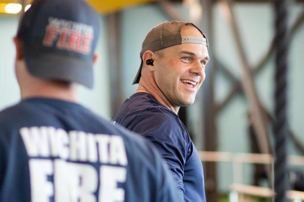 Firefighter Tony Massaglia passes Fire Station 10 Lieutaunt John Hattrup as the men tease each other about their workouts. The two make up a fire crew that has been together for around five years.