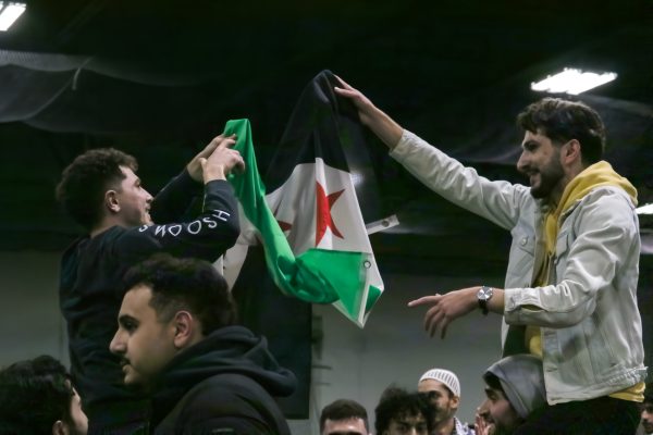 The Syrian flag is held proudly above the crowd during Friday night's tournament. Players and crowdmembers met for the "Celebration & Soccer For Syria Tournament" for a sports and community driven evening.