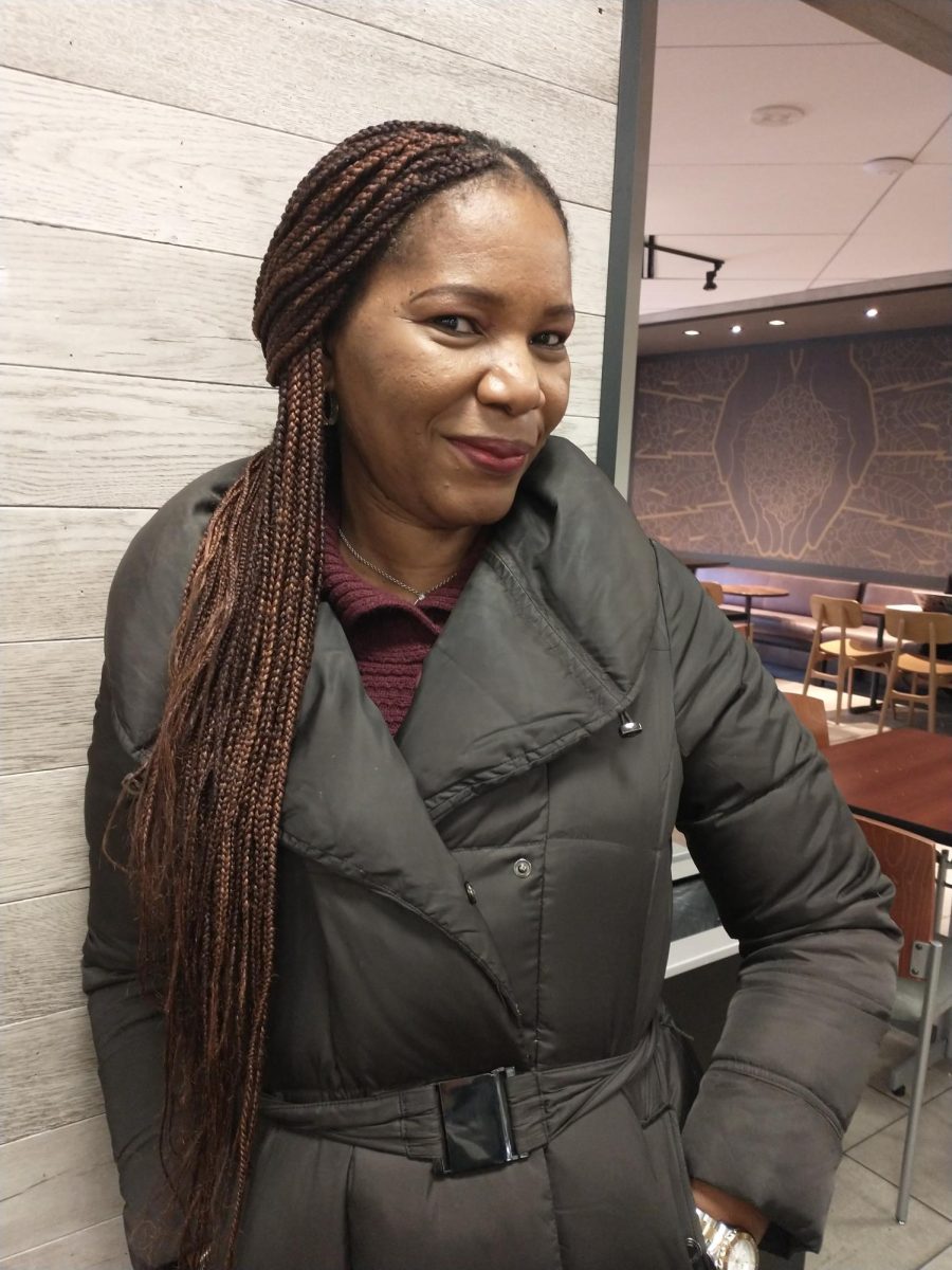 Mercy Umeri stands in the Starbucks lounge at the Rhatigan Student Center. 