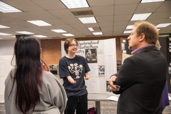 Freshman Nadia Goodwin presents her project on the popularization of LGBTQ in the music industry to associate professor of modern European history Jeff Hayton. Goodwin said that because her major is communications with an emphasis in journalism and media production, doing a project like this is "perfect" in aiding skills needed for her career.