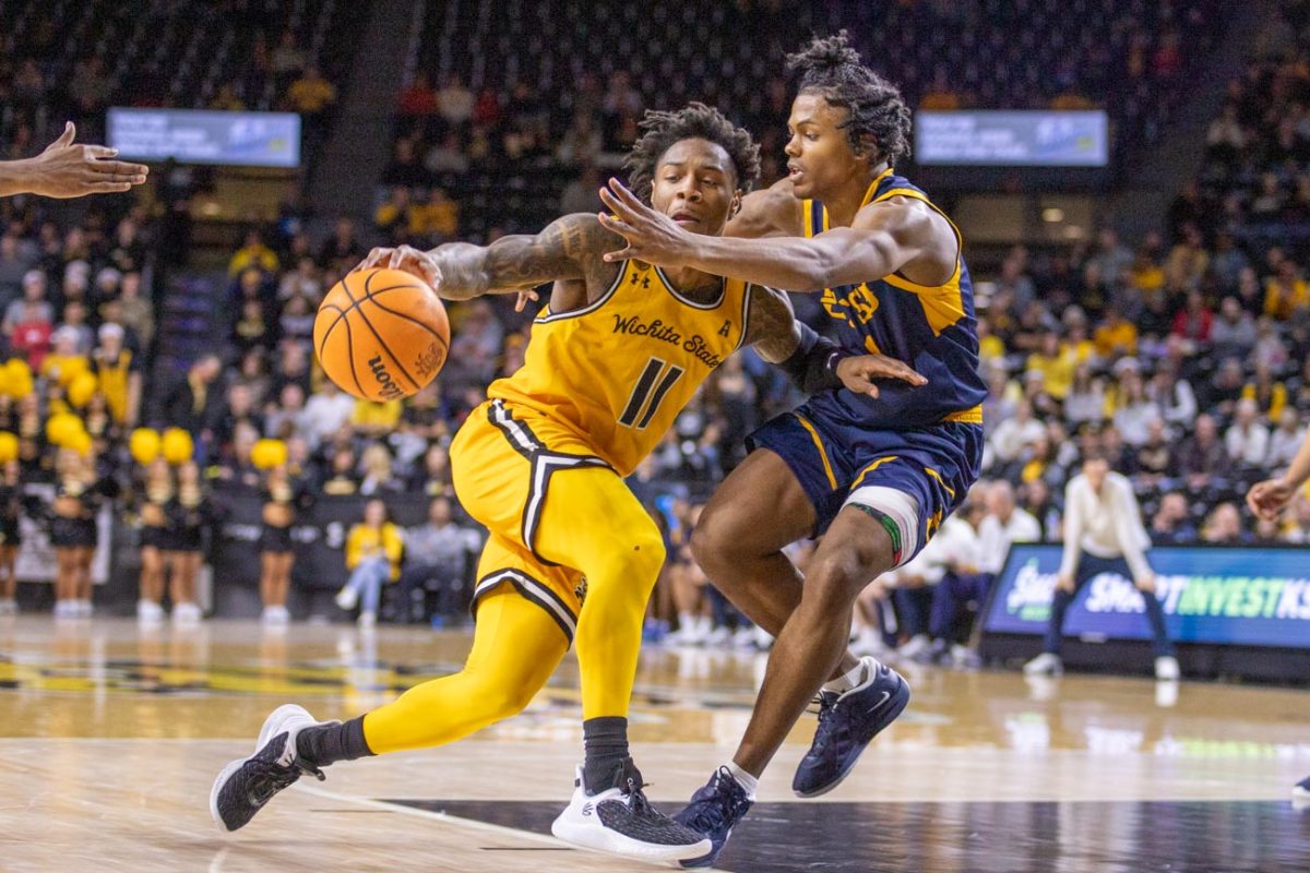 Fifth-year guard Justin Hill drives into the paint against East Tennessee State on Dec. 7. Hill led the Shockers with 20 points in the win.