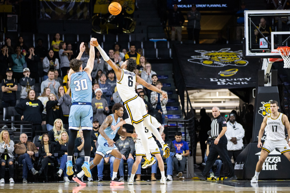 Kansas City's Cameron Faas puts up for a two-point shot as Wichita State's Corey Washington attempts a block. Washington occupied the court for nearly 30 minutes, scoring eight points.