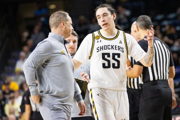 Head coach Paul Mills and senior guard Bijan Cortes talk after a timeout. The Shockers played the Kansas City Roos on Dec. 17, losing 74-64.