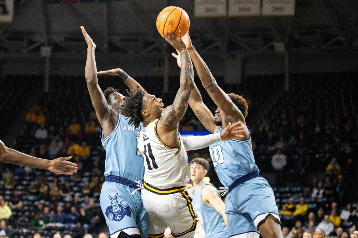 Fifth-year guard Justin Hill attempts to score after grabbing a rebound. Hill was one of the top scorers of the evening, tallying 12 points in the game.