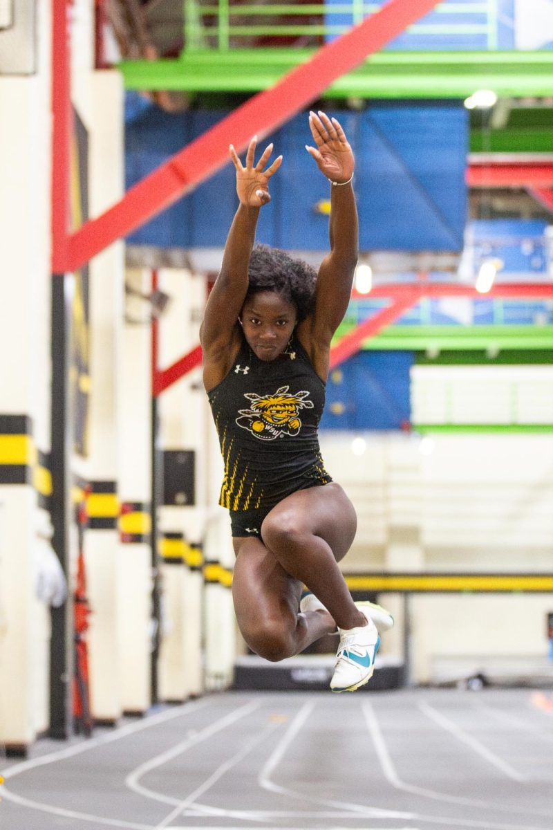 Kennady Washington leaps forward during the Black vs. Yellow Intrasquad event on Dec. 6.  Washington competes in both sprints and jumps for track and field.