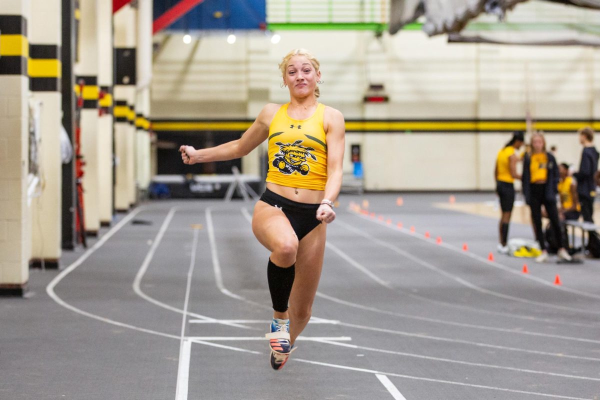 Anna Bundy jumps forward during the Black vs. Yellow Intrasquad event on Dec. 6. Bundy competes in multiple track and field events.