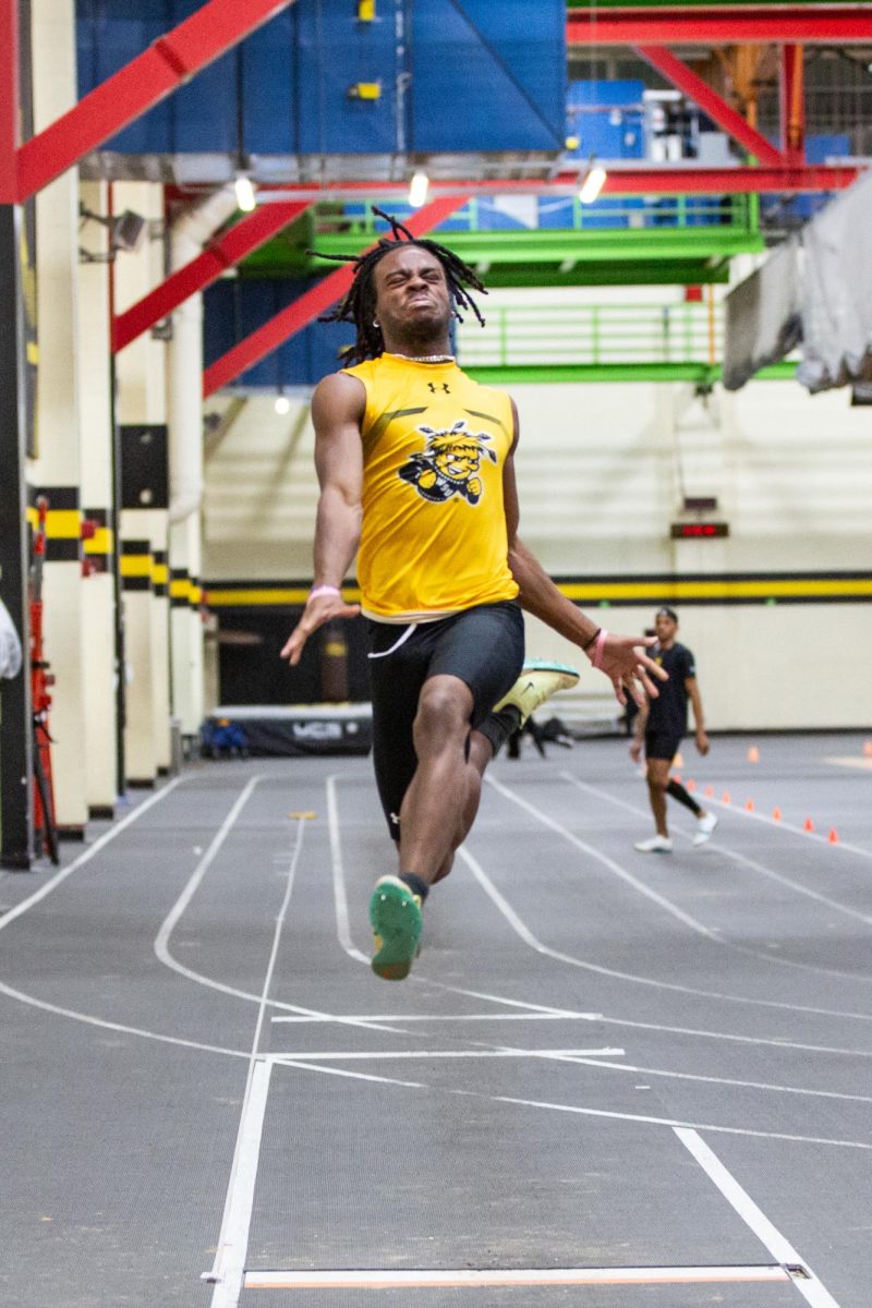 Chairo Ogbebor jumps forward during the Black vs. Yellow Intrasquad event on Dec. 6. Ogbebor competes in sprint and jump events for track and field.