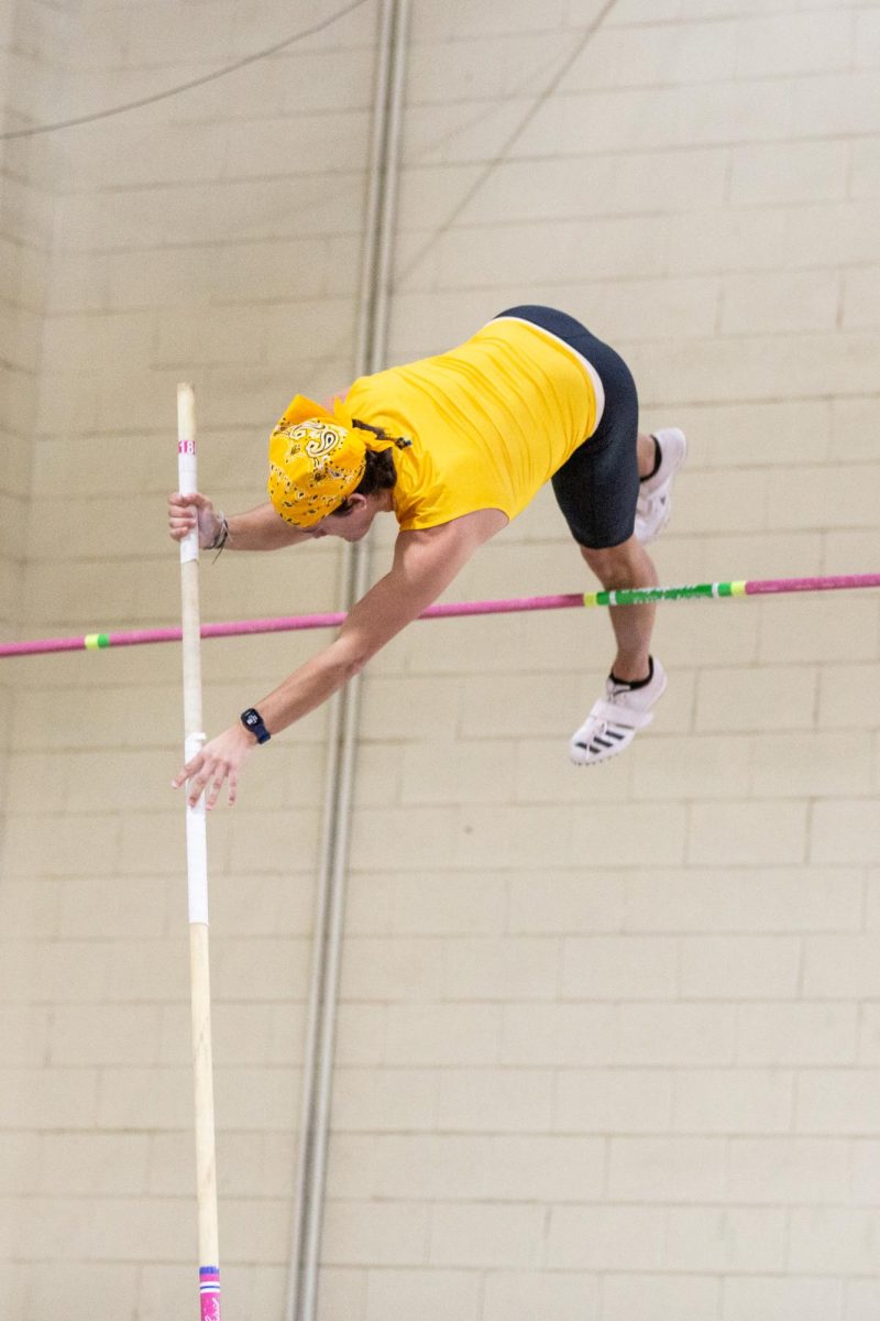 Weston Hulse propels himself over the pole vault bar during the Black vs Yellow Intrasquad match on Dec. 6.