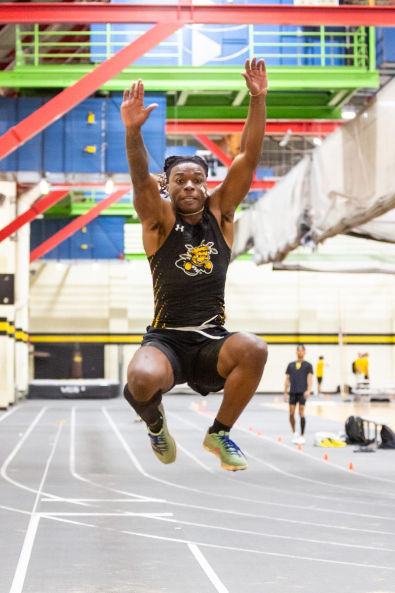 Amarrion Reese leaps forward during the Black vs. Yellow Intrasquad event on Dec. 6. Reese competes in sprint and jump events for track and field.