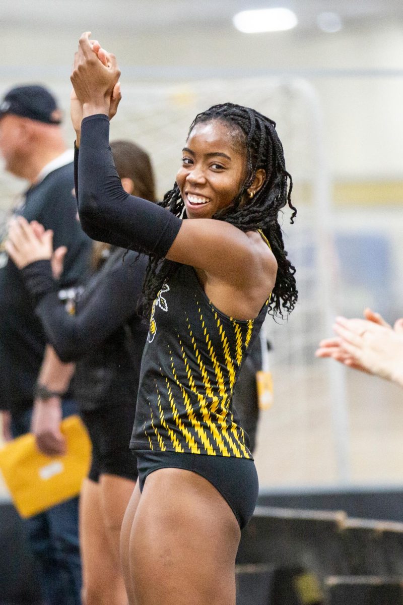 Chidera Okoro claps for Farrah Miller after she competed in the high jump at the Black vs. Yellow Intrasquad event on Dec. 6.