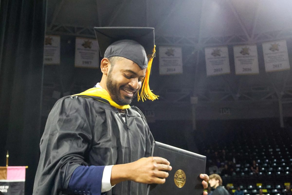 Srikanth Reddy Kurri looks down at his diploma. Kurri received a Masters of Science.