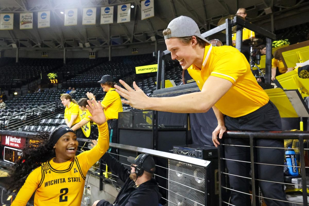 Freshman guard KP Parr high-fives a member of the WSU pep band after the Shockers' win on Dec. 2. Parr played 18 minutes in the game.