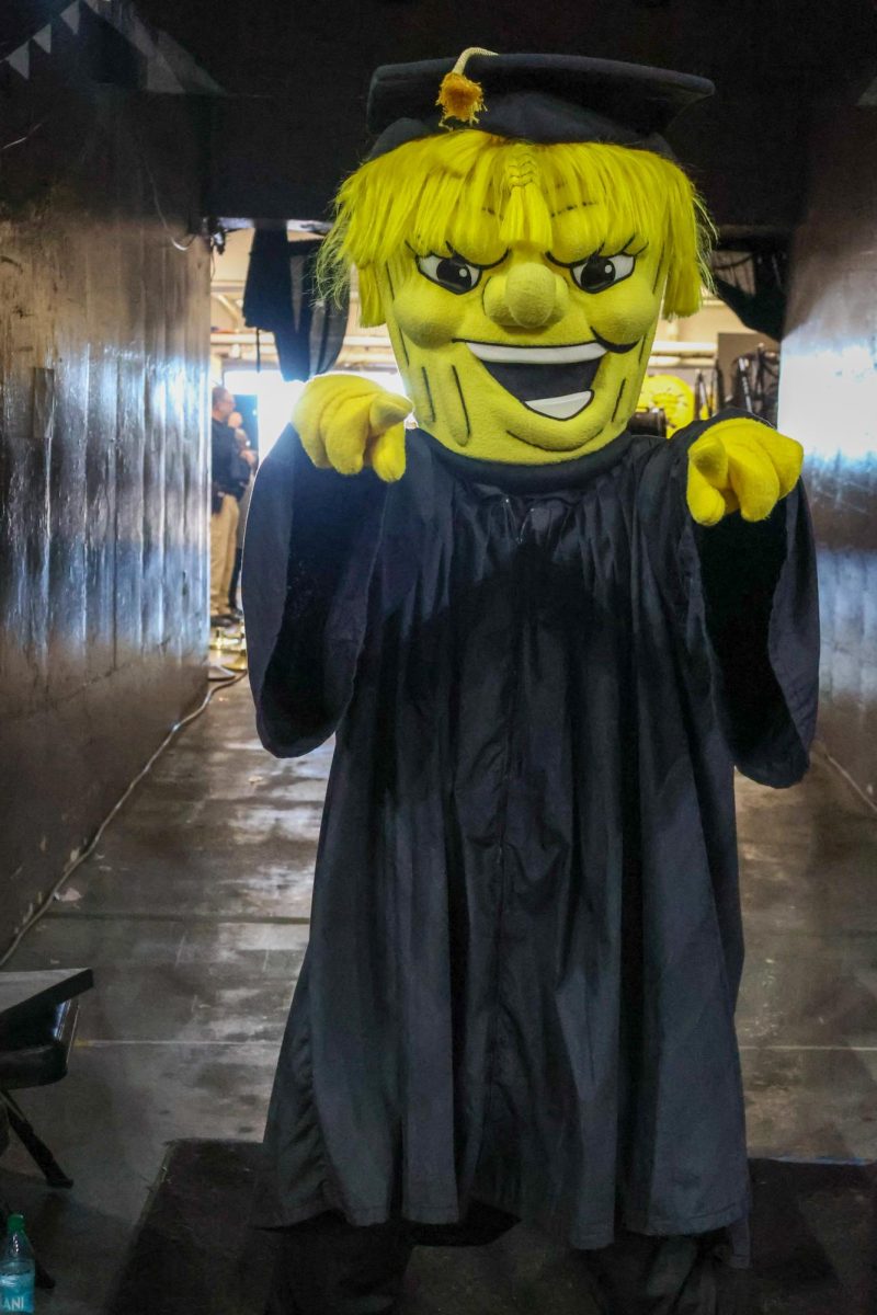 WuShock poses in his cap and gown.