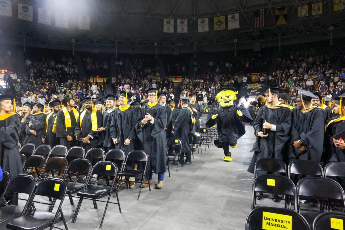 WuShock leads out the Shocker Sound Machine. The band played the fight song at the conclusion of the 2024 Fall Commencement ceremony.