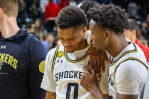 Fifth-year guard AJ McGinnis and sophomore guard Joy Ighovodja talk after the Dec. 29 game against Friends. McGinnis and Ighovodja combined for 12 points.