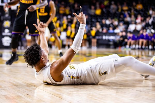 Junior forward Corey Washington lays after a fall in the second half. Washington scored 19 points and 18 rebounds against the East Carolina Pirates.