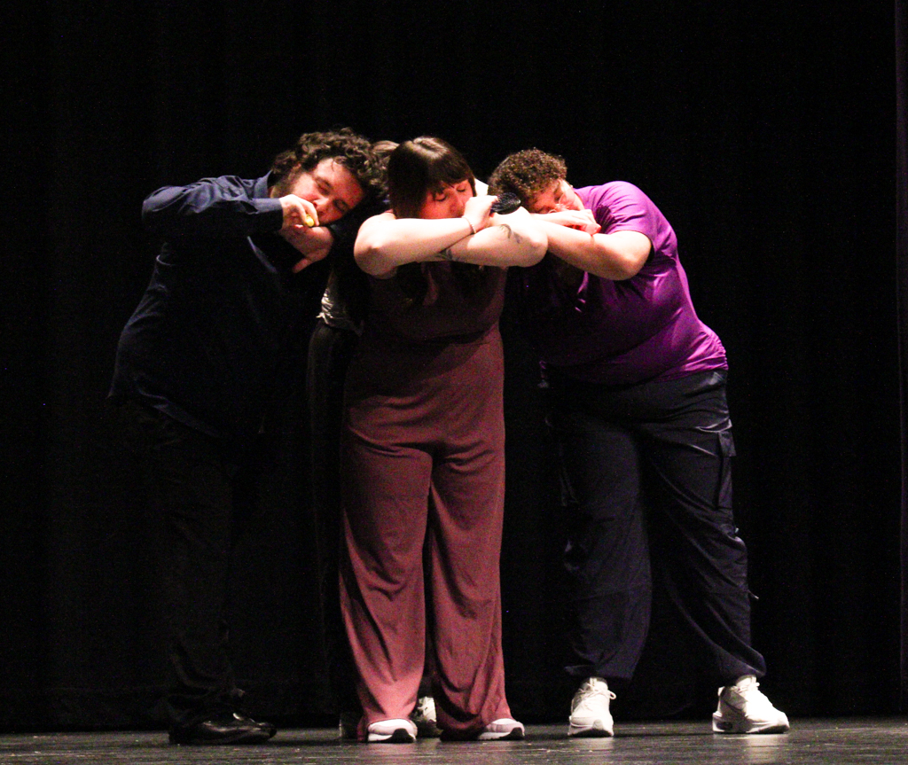 Performers strike a "sleeping" pose during their performance of Saturn by Sza. The Shockappellas hosted an open dress rehearsal in preparation for their Nebraska competition.