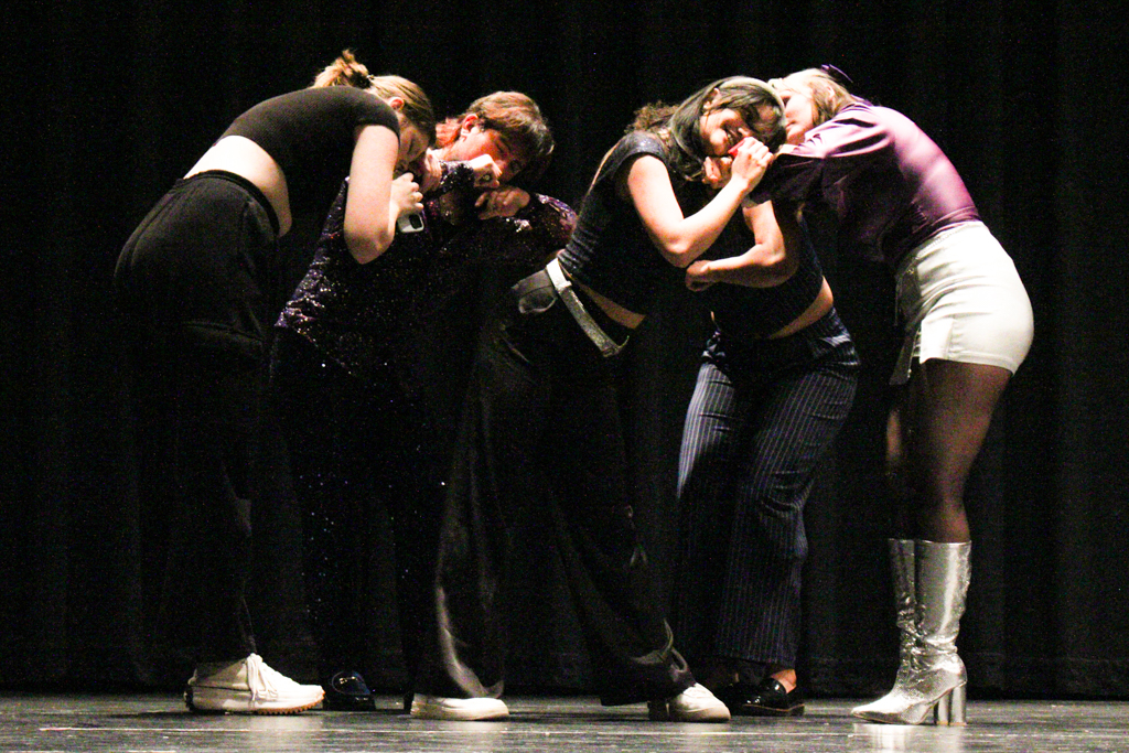 Shockappella performers strike a pose as a part of their "Saturn" by SZA performance. They hosted an open dress rehearsal as preparation for their Nebraska competition.