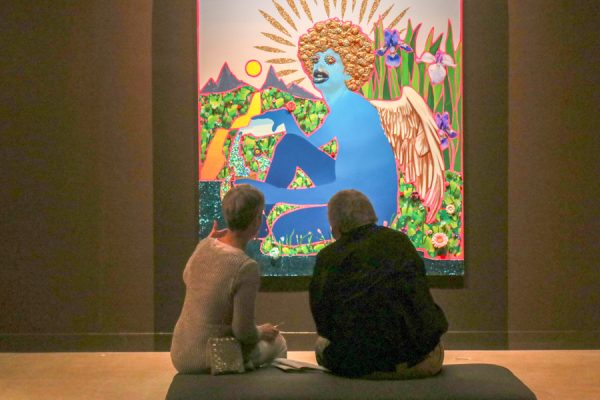 Rachel Muscat and David Parks discuss in the "Devan Shimoyama Rituals" exhibit. The exhibit's titular artist, Devan Shimoyama, mixes the composition styles of classical and contemporary art.