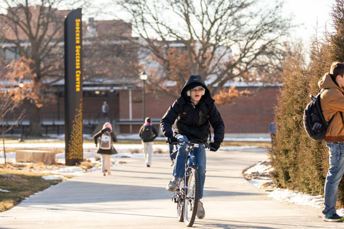 A Wichita State student zips through campus on a bike during the second day back to class. Wichita State started its first day of classes remotely before resuming in person on Wednesday, Jan. 22.