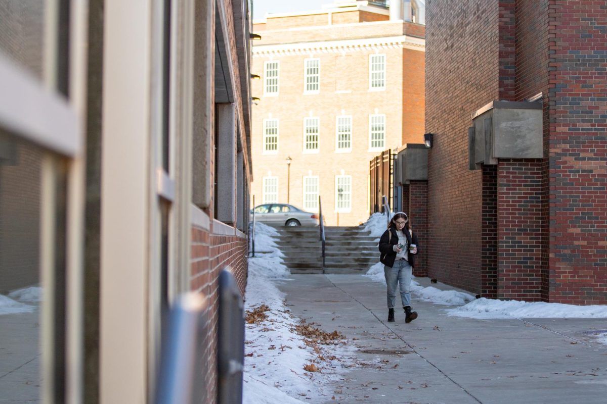 Coffee in hand, Claire Stewart walks around Wichita State between classes, attempting to familarize herself with the campus on Jan. 22.