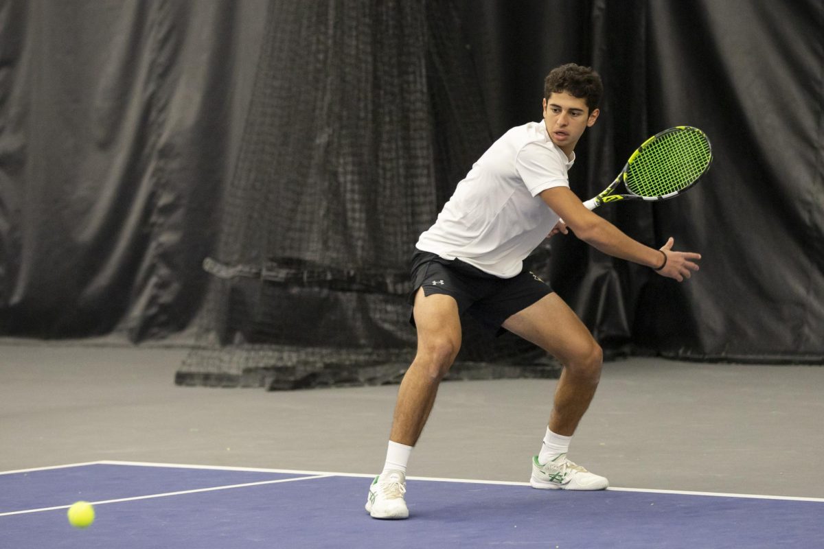 Zaid Al Mashni prepares to hit the ball during a doubles match with Luca Mindrut on Jan. 26. The men's tennis team defeated Drake University, 7-0.