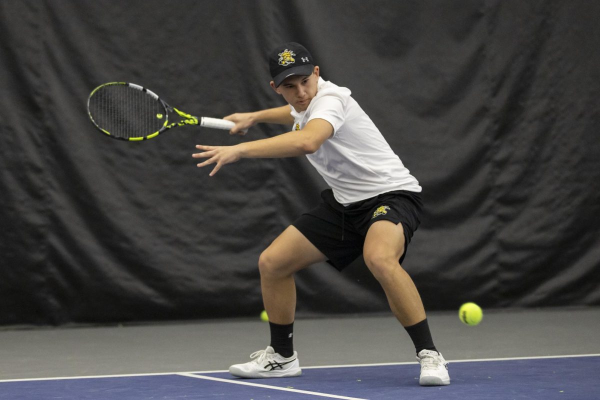 Luca Mindrut prepares to send the ball across the net during a singles match against a Drake University player. 