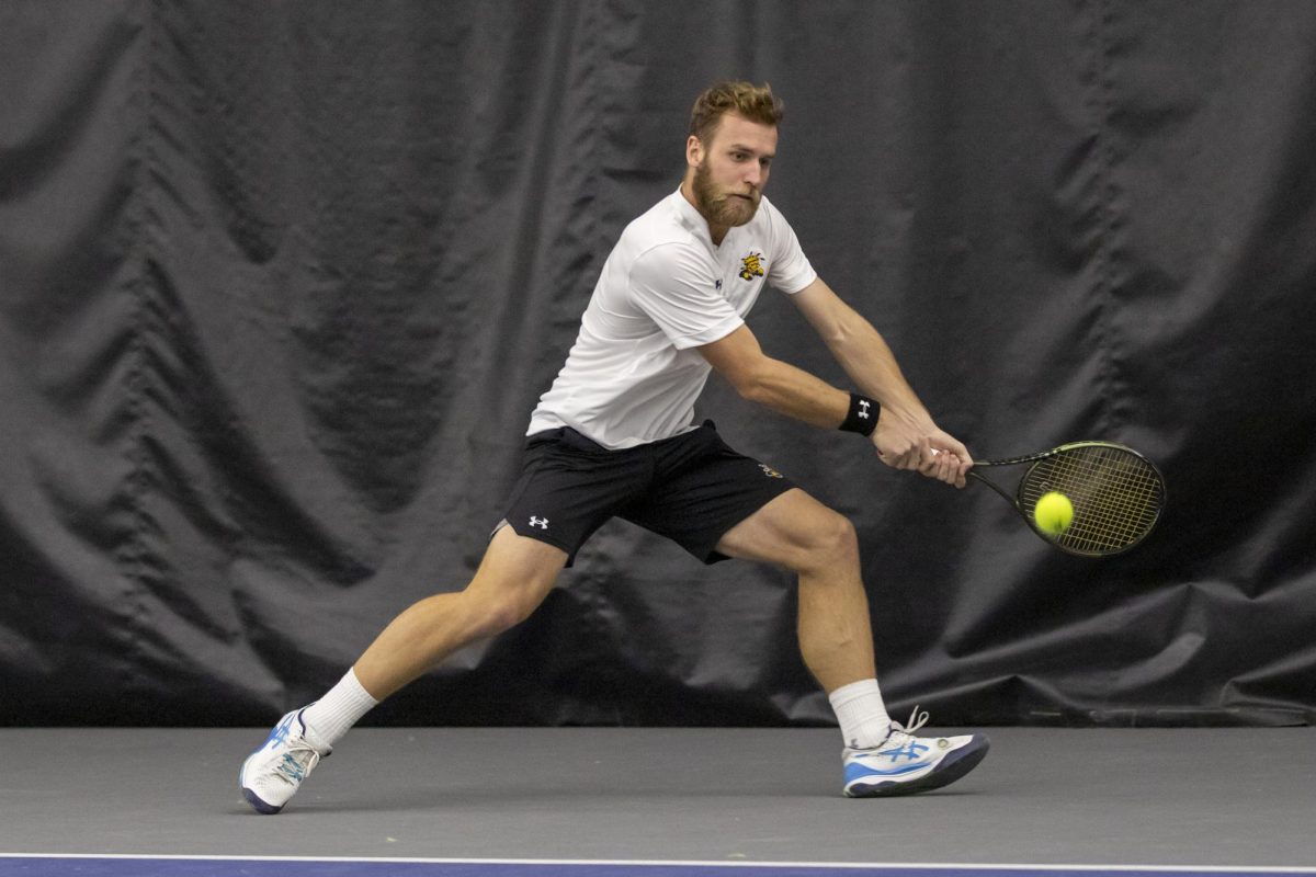 Kristof Minarik sends the ball to a Drake University opponent during a Jan. 26 tennis match.