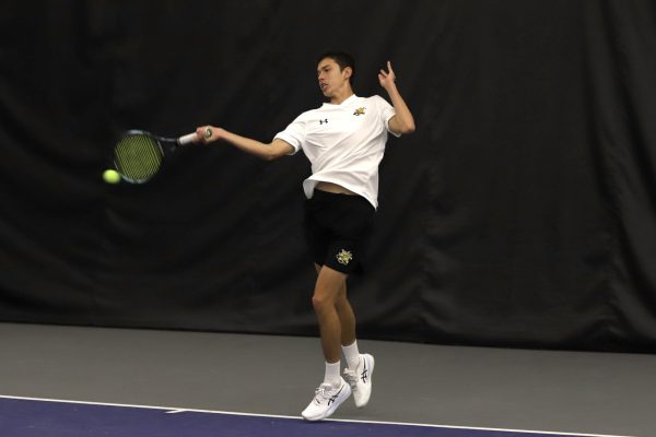 Freshman Amir Milushev returns the ball during Wichita State's tennis match against Drake on Jan. 26. Milushev picked up a singles win during Wichita State's sweep.