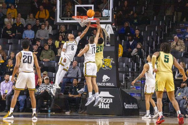 Corey Washington and Matej Bošnjak attempt to block a Charlotte layup on Jan. 14. Wichita State won, 68-59, on Tuesday night.