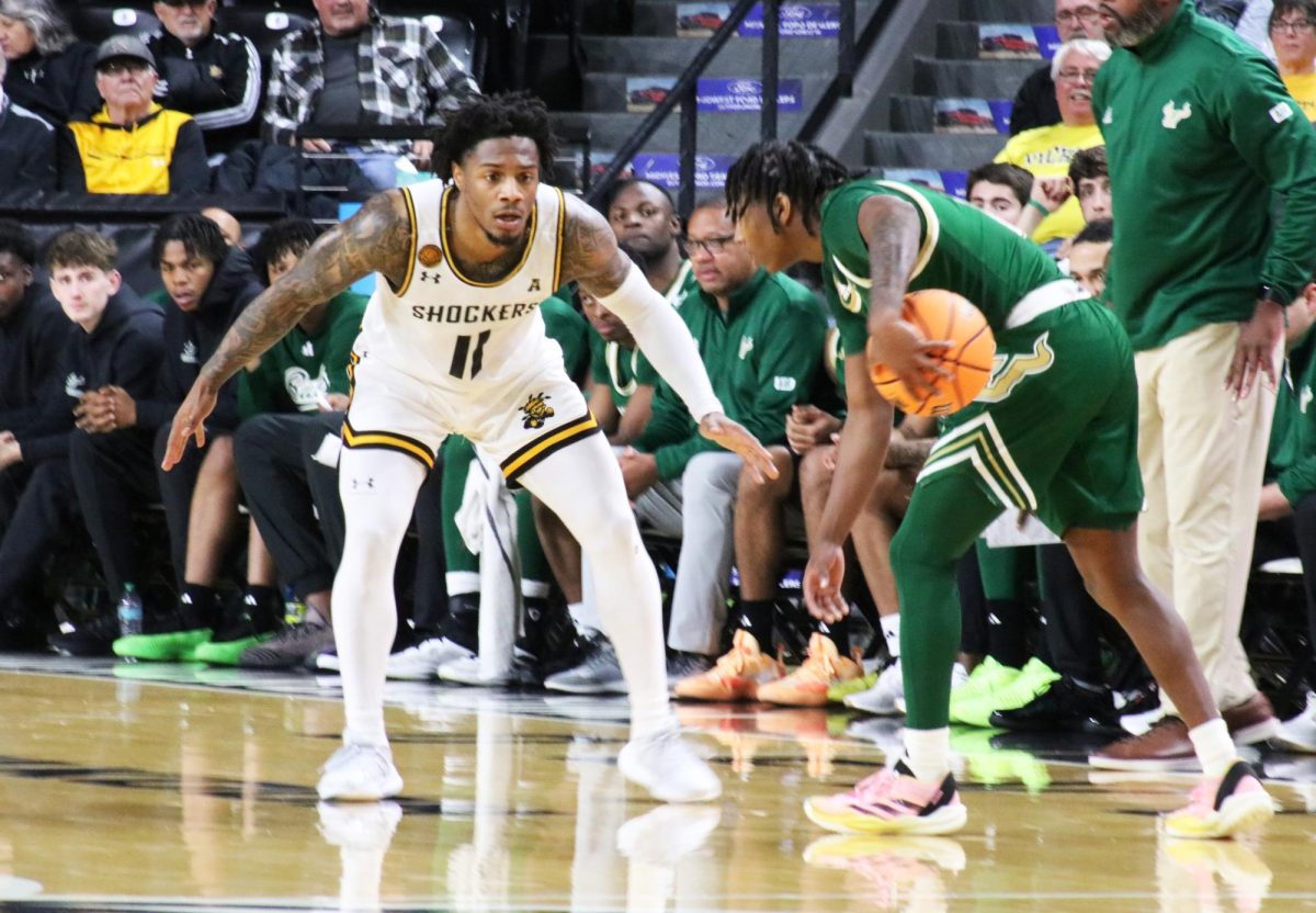 Fifth-year guard Justin Hill defends a South Florida player on Jan. 6. For the second consecutive game, Wichita State allowed 91 points in a conference loss, 91-72.