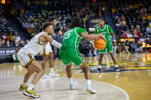 Senior guard Xavier Bell defends against UNT's senior guard Jasper Floyd in the second half. Bell contributed 19 points and one assist during Wednesday's game.